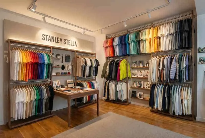 Stanley/Stella showroom interior in Bochum with colour-sorted T-shirts on wooden rails